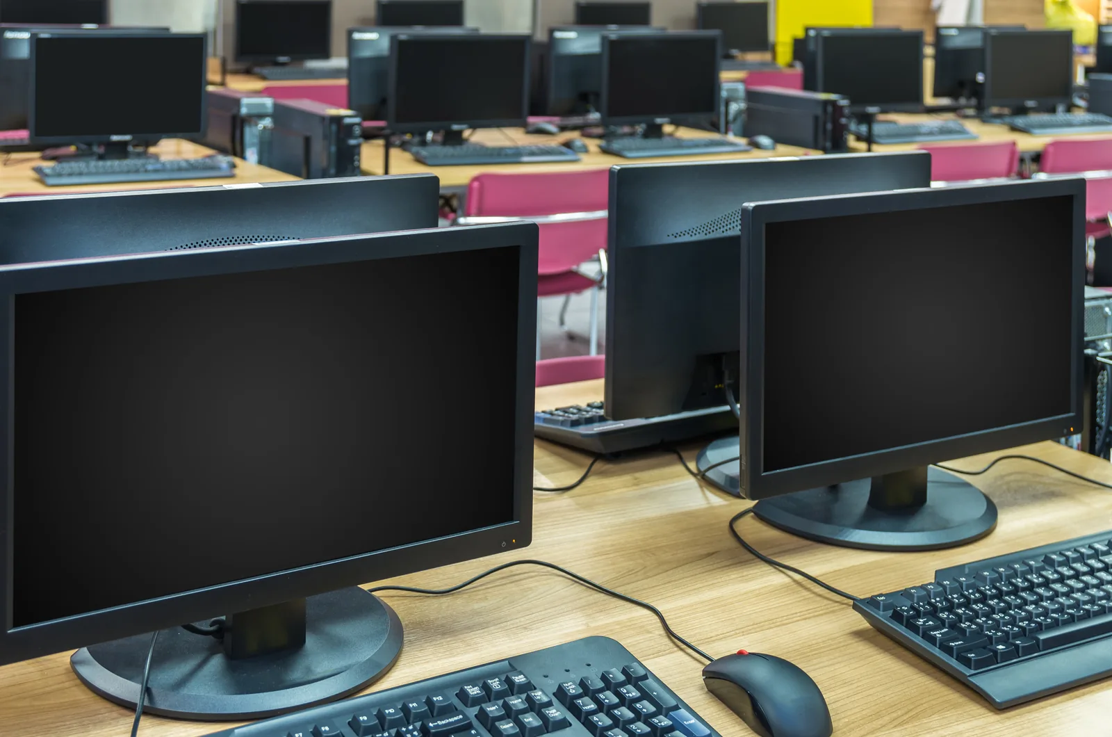 Rows of business desktop computers ready for deployment